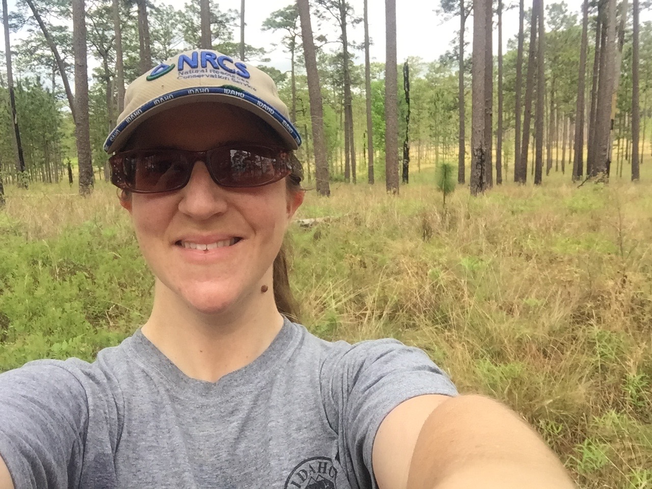 Dewind Awardee, Molly Wiebush taking a selfie in a forest.