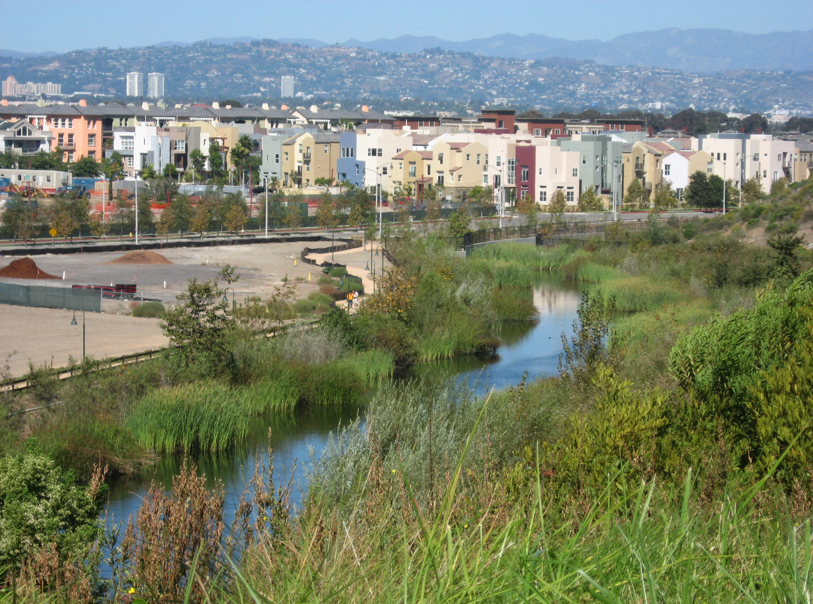 "An urban waterway adjacent to housing"