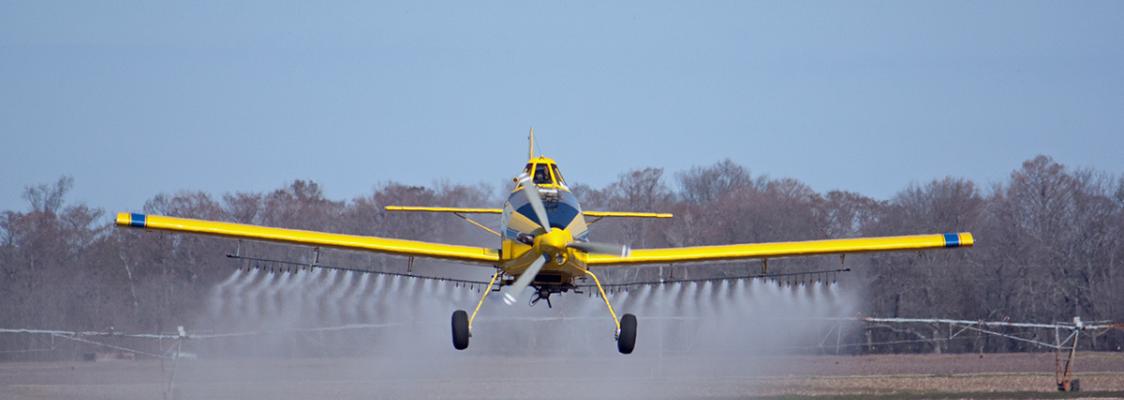 Crop-duster applying herbicide